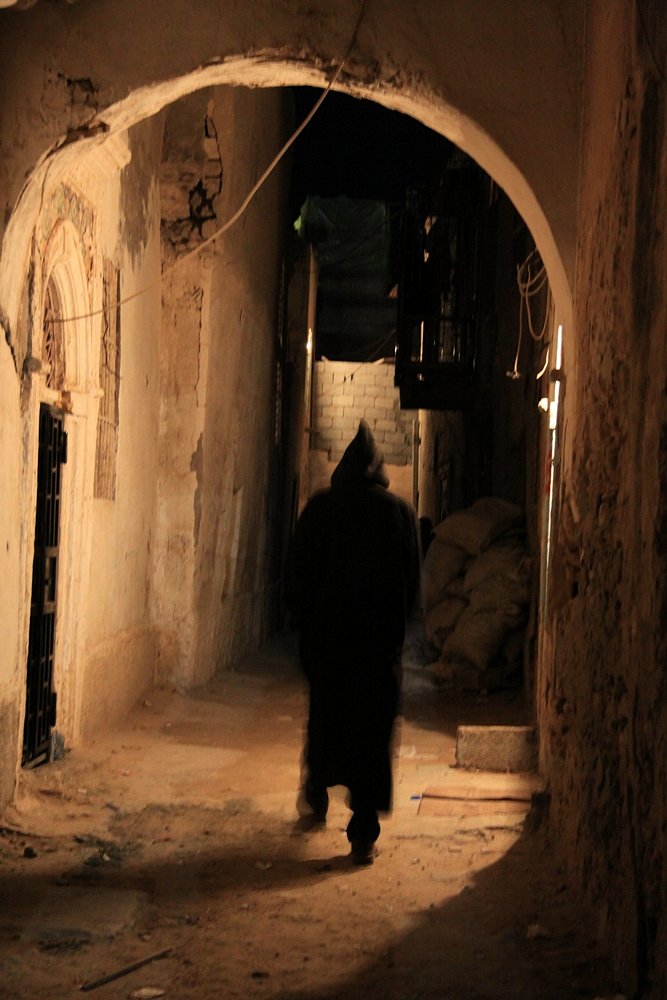 A Marrocan immigrant is wandering in the narrow alleys of the old town.